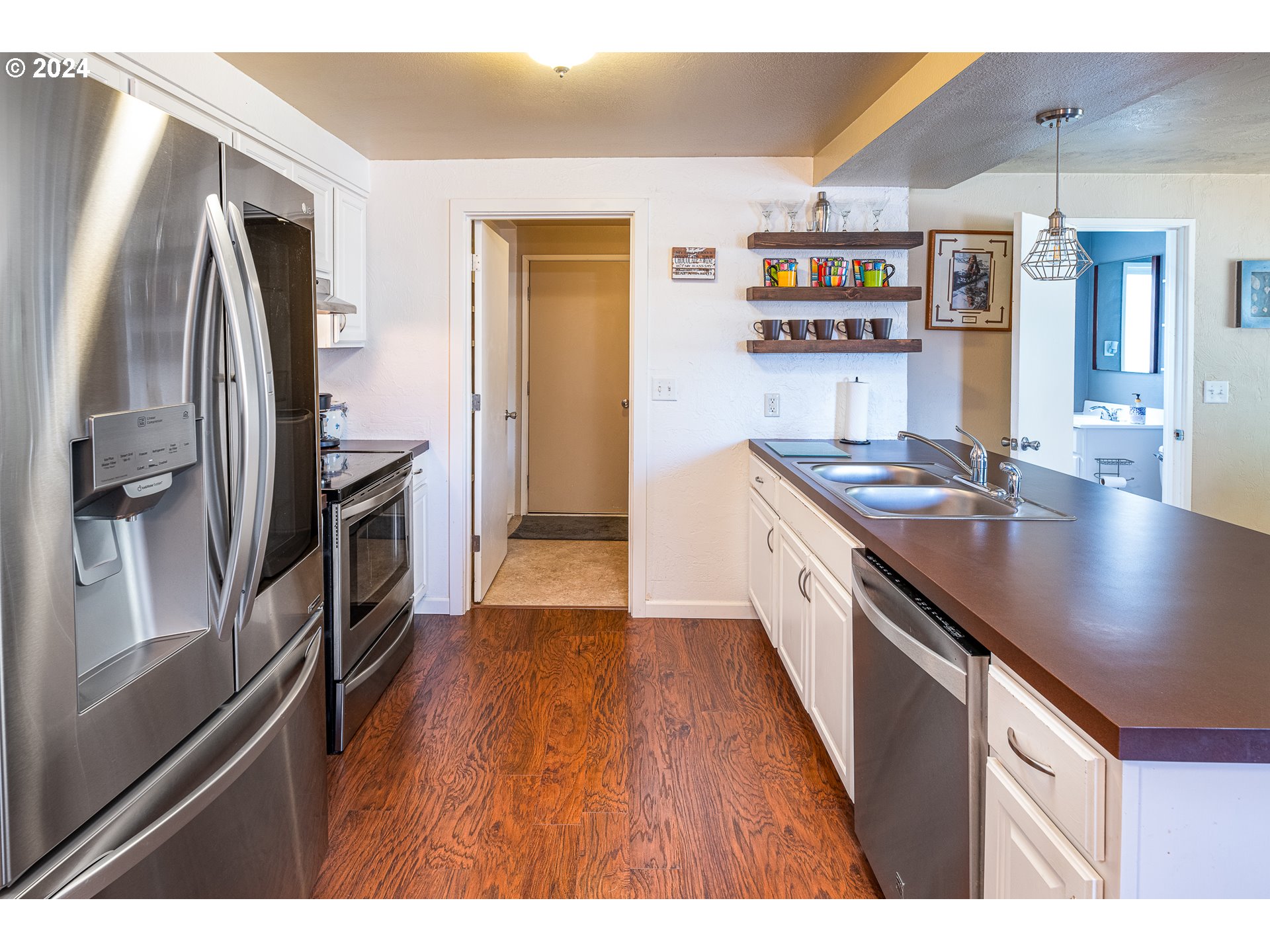 3870 Richland Street Springfield, OR 97478 - Photo 31 of 41 a kitchen with stainless steel appliances granite countertop a stove and a refrigerator