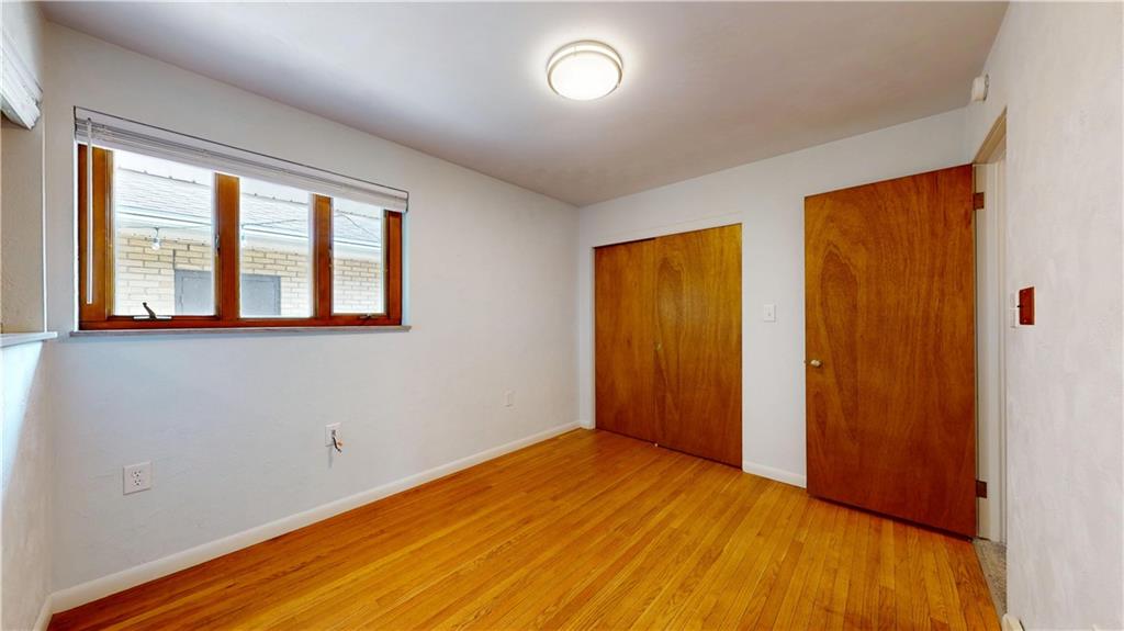 721 Herman Road Butler, PA 16002 - Photo 23 of 32 a view of an empty room with wooden floor and a window