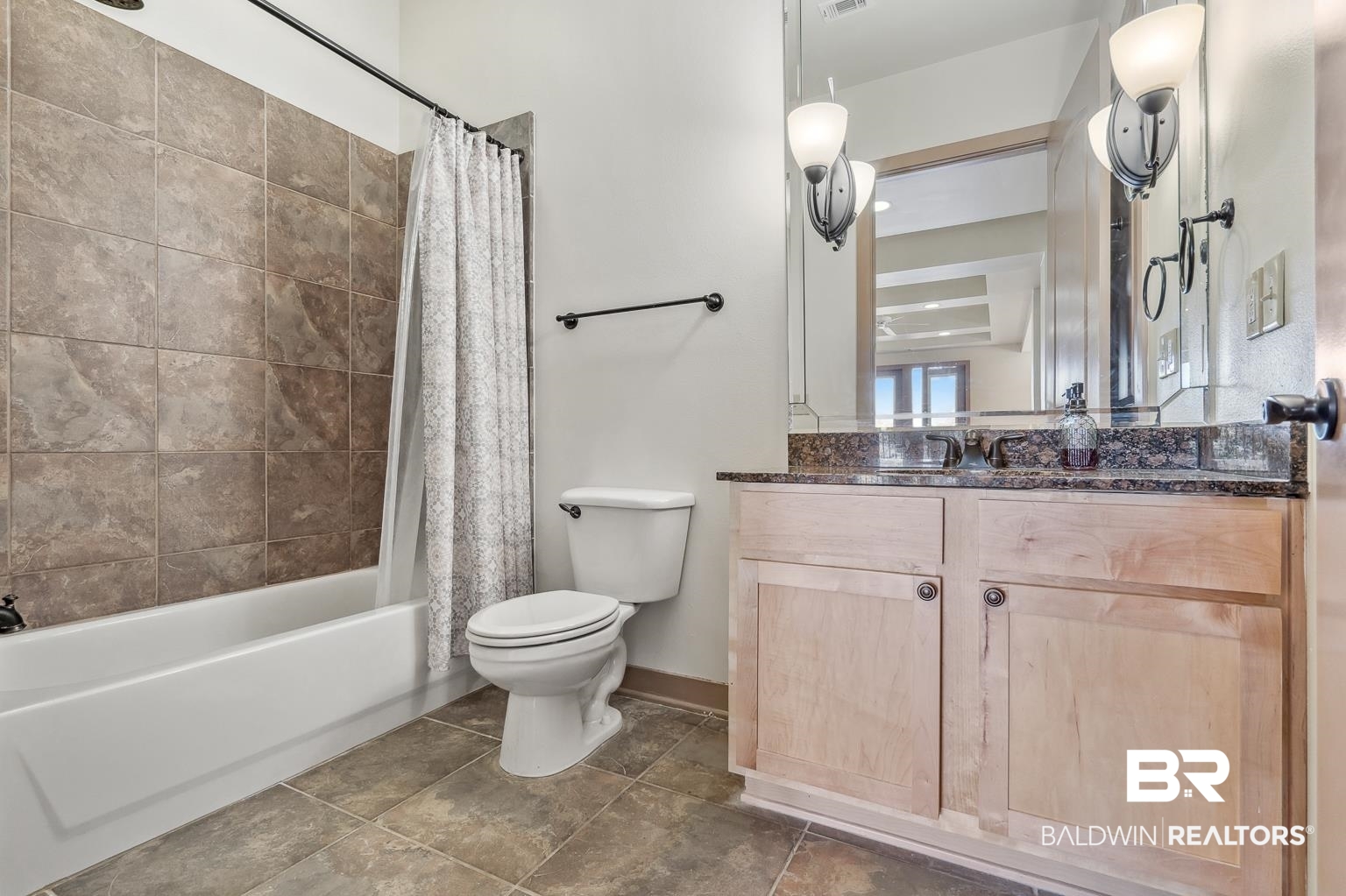 1430 Regency Road, Unit H201 Gulf Shores, AL 36542 - Photo 39 of 49 Bathroom with visible vents, toilet, shower / bath combo with shower curtain, vanity, and tile patterned flooring