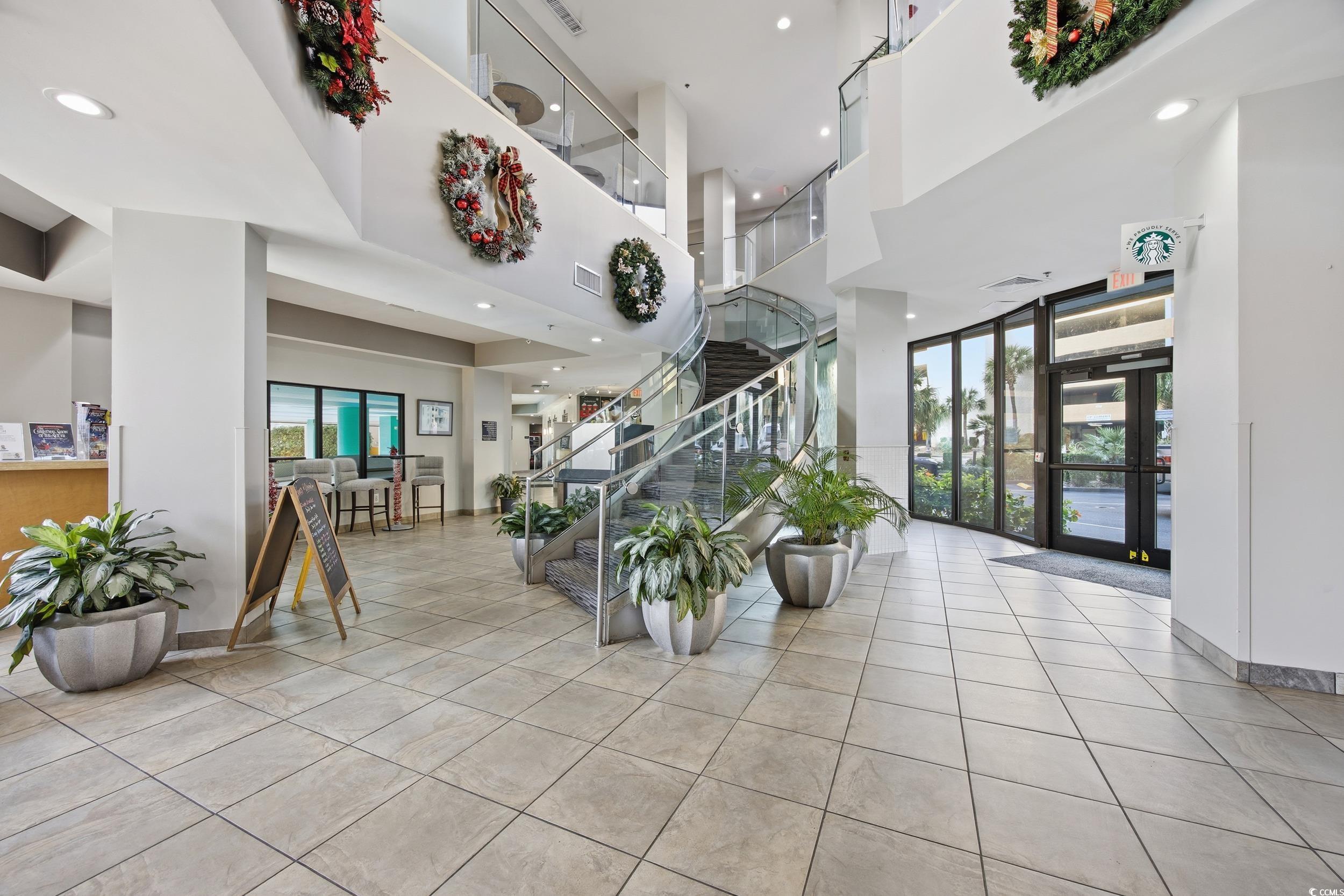 2710 North Ocean Boulevard, Unit 702 Myrtle Beach, SC 29577 - Photo 14 of 38 Lobby with a towering ceiling, stairway, and recessed lighting