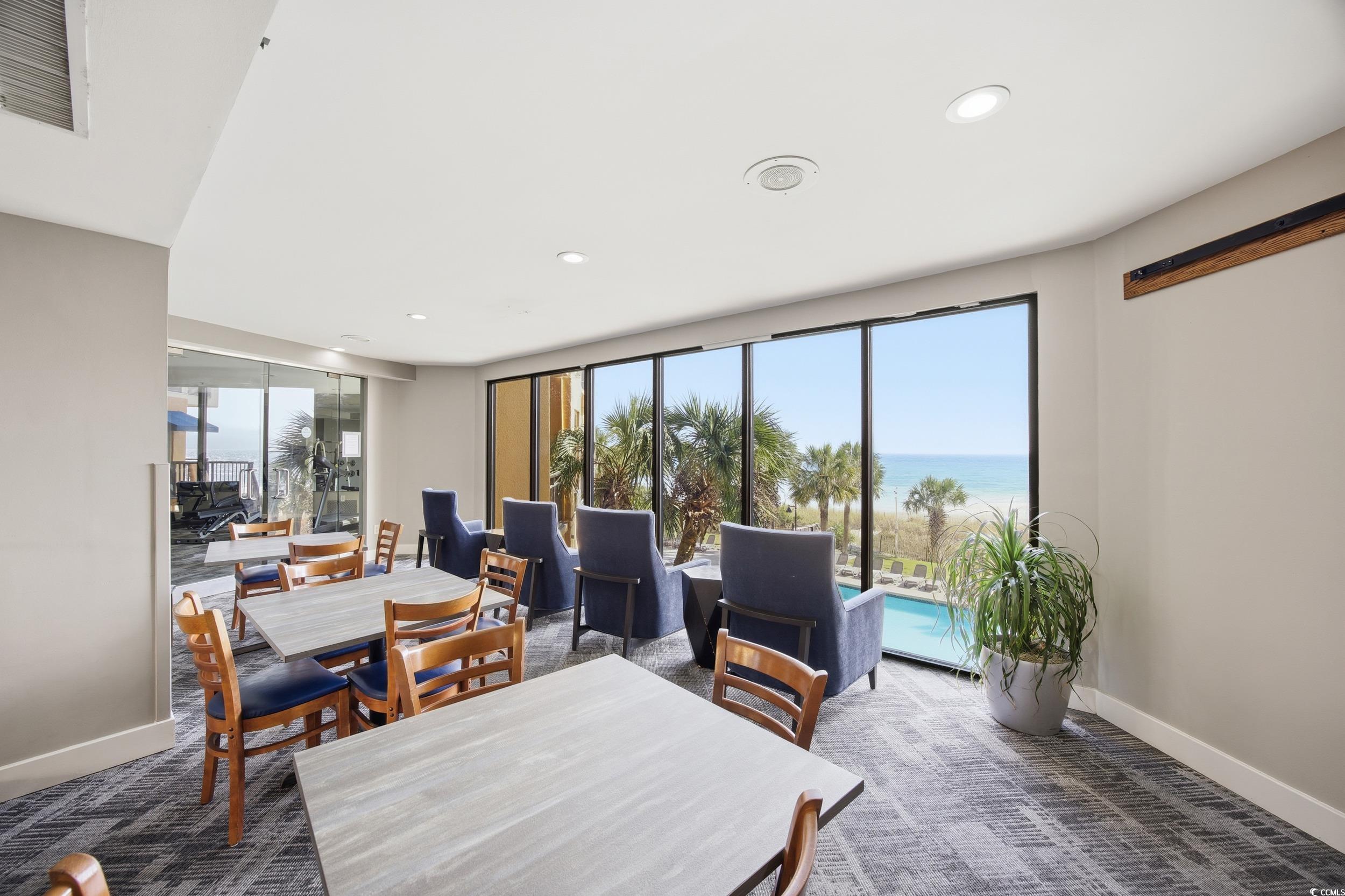 2710 North Ocean Boulevard, Unit 702 Myrtle Beach, SC 29577 - Photo 15 of 38 Dining room featuring a water view, plenty of natural light, recessed lighting, and dark colored carpet