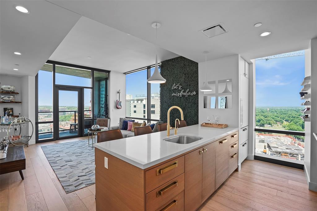 70 Rainey Street, Unit 1409 Austin, TX 78701 - Photo 38 of 38 Kitchen with expansive windows, light wood finished floors, open floor plan, a peninsula, and plenty of natural light