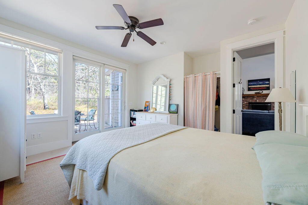 43 South Highland Road Truro, MA 02666 - Photo 12 of 40 a spacious bedroom with a bed and a chandelier