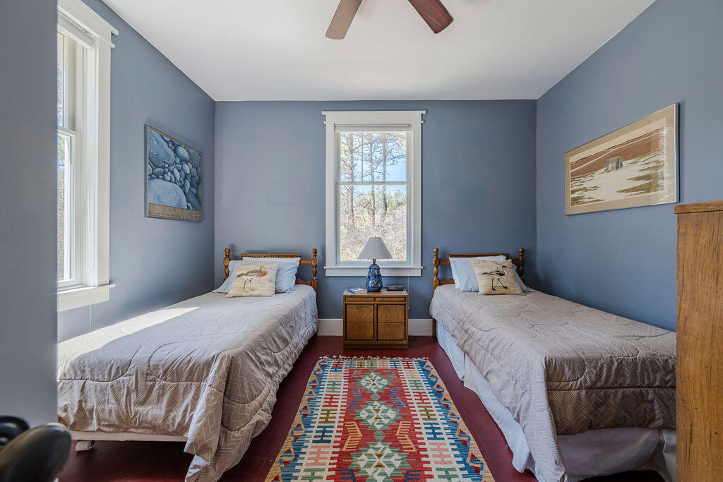 43 South Highland Road Truro, MA 02666 - Photo 15 of 40 a bedroom with a bed and wooden floor