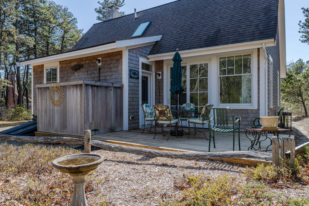 43 South Highland Road Truro, MA 02666 - Photo 23 of 40 a backyard of a house with yard and outdoor seating