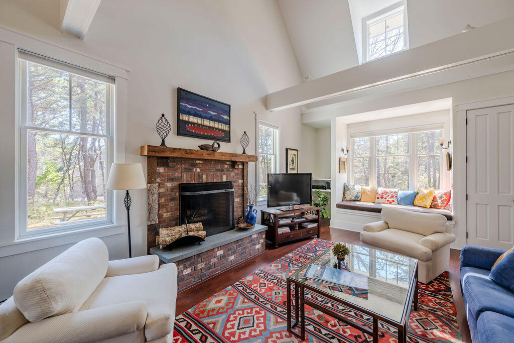 43 South Highland Road Truro, MA 02666 - Photo 4 of 40 a living room with furniture a large window and a fireplace