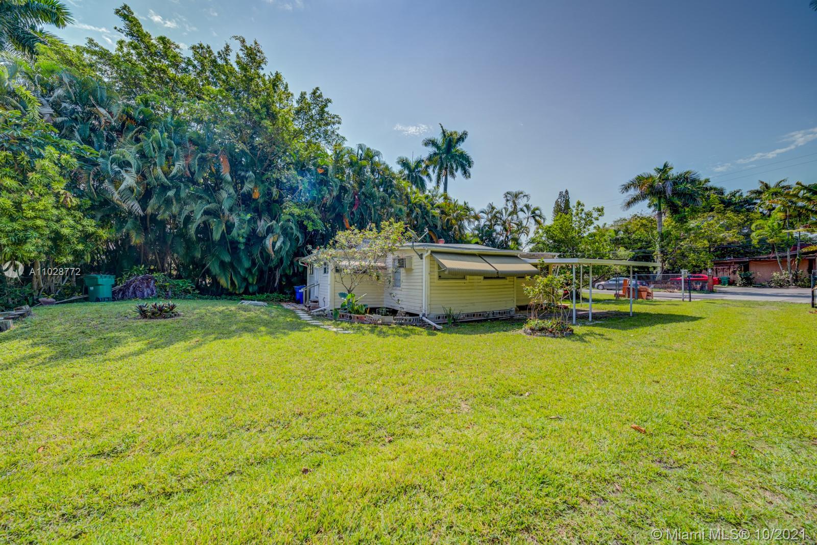477 Northeast 154th Street Miami, FL 33162 - Photo 12 of 26 a view of a house with pool and a garden