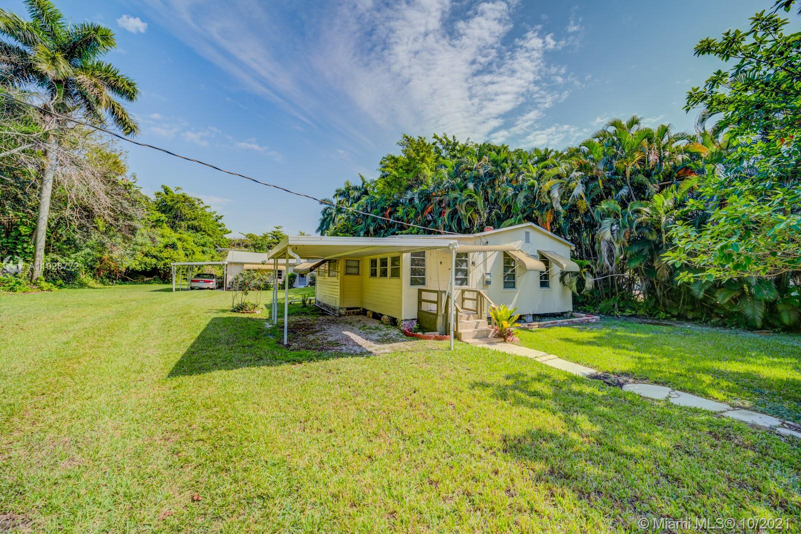 477 Northeast 154th Street Miami, FL 33162 - Photo 13 of 26 a view of a house with a yard patio and swimming pool