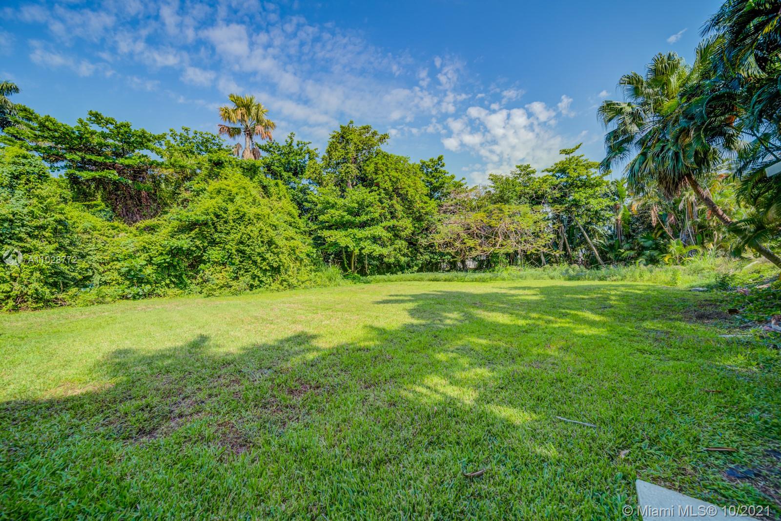 477 Northeast 154th Street Miami, FL 33162 - Photo 14 of 26 a view of a garden with a tree