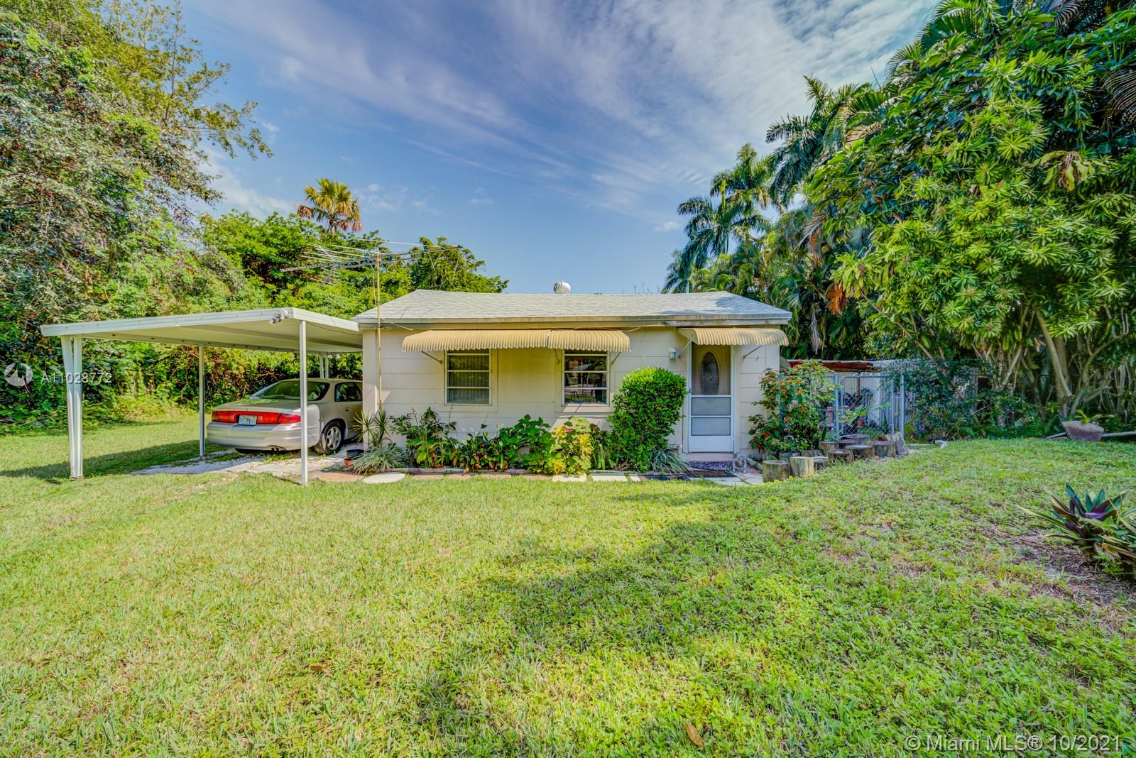 477 Northeast 154th Street Miami, FL 33162 - Photo 15 of 26 a view of a house with a yard and sitting area