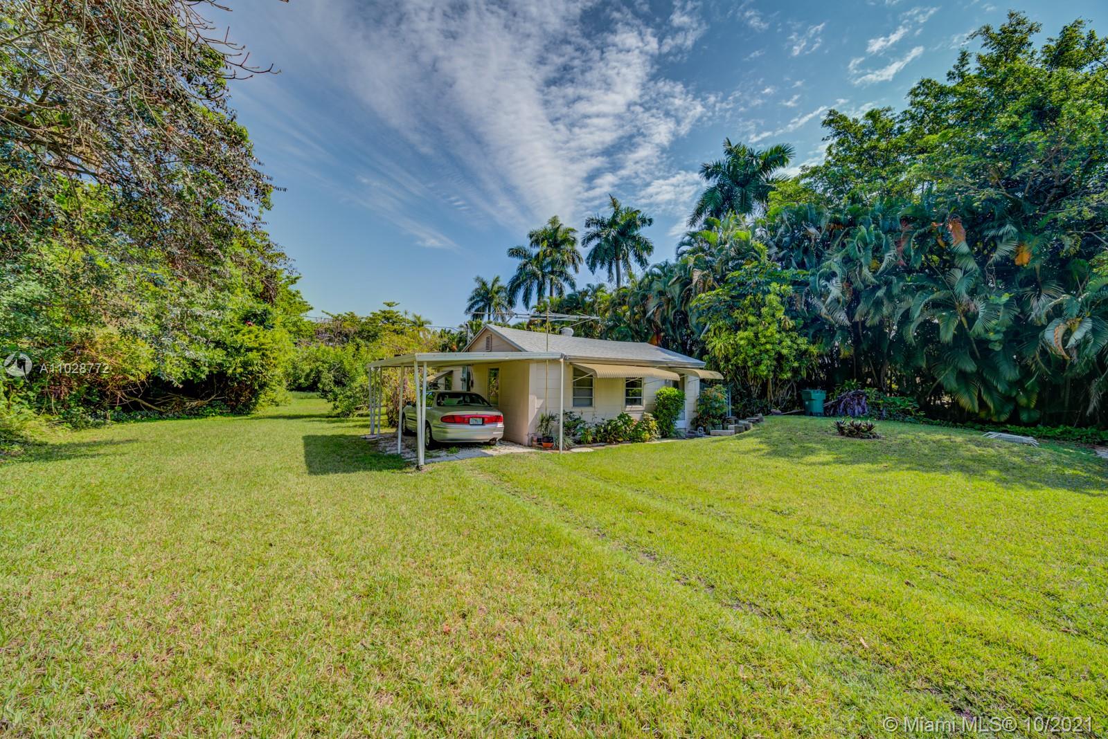 477 Northeast 154th Street Miami, FL 33162 - Photo 17 of 26 a view of a house with a yard