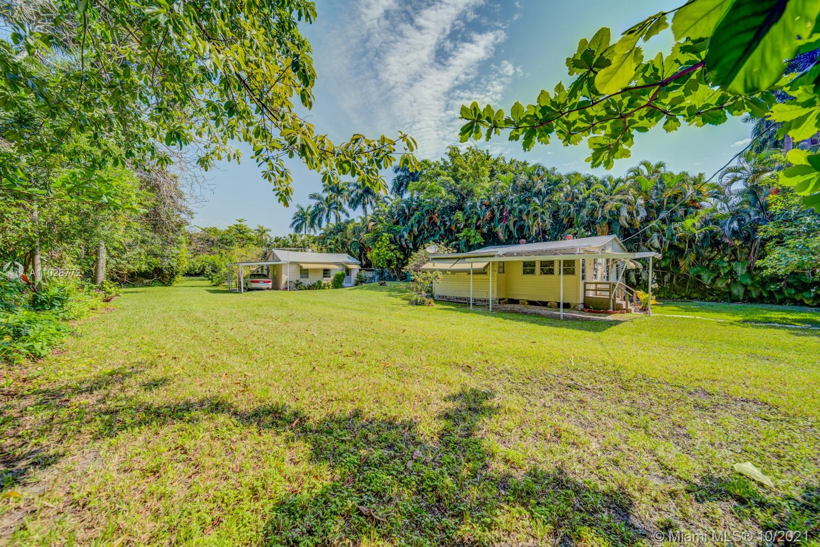 477 Northeast 154th Street Miami, FL 33162 - Photo 18 of 26 a yellow house with swimming pool in front of it