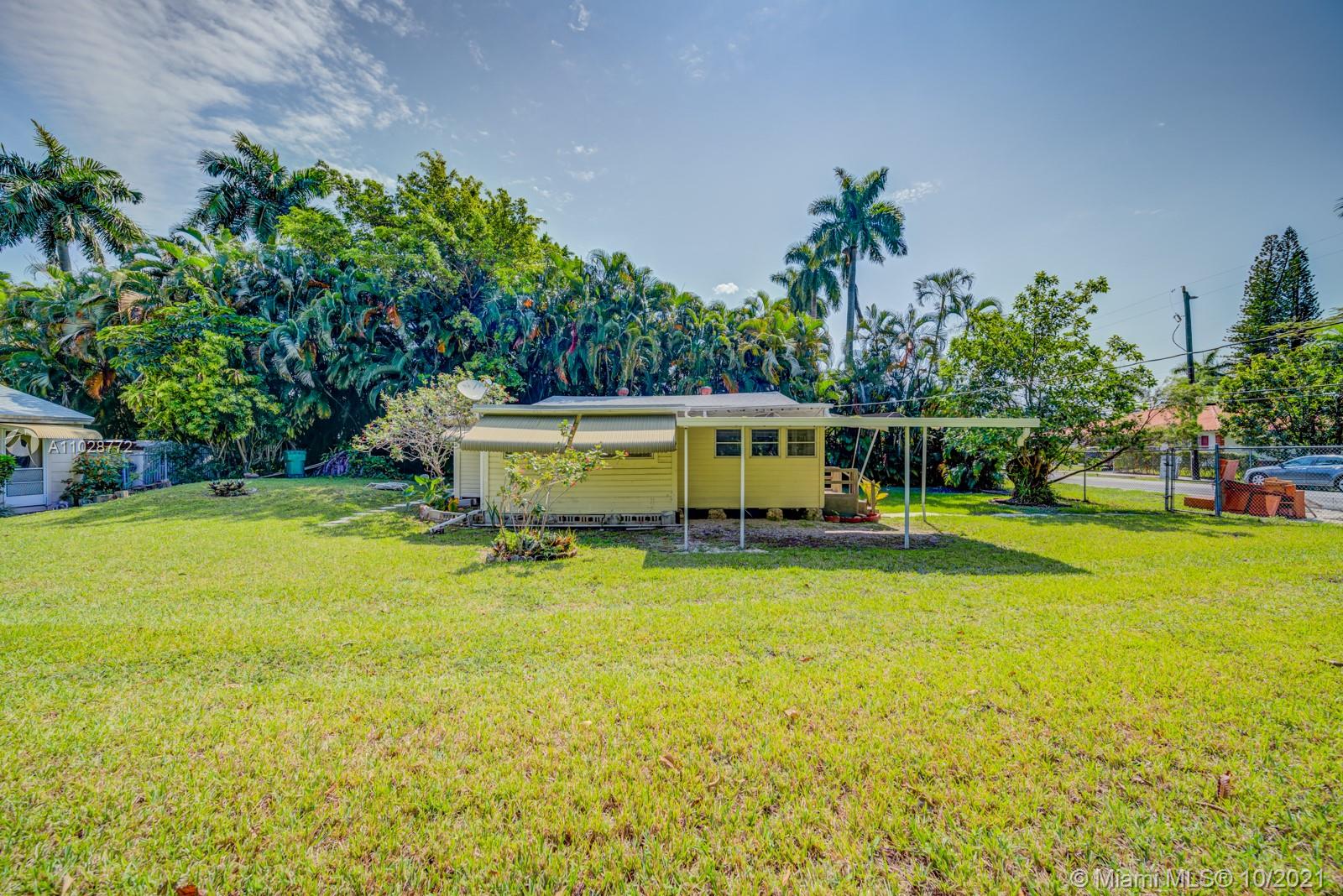 477 Northeast 154th Street Miami, FL 33162 - Photo 21 of 26 a view of a swimming pool with lawn chairs and plants