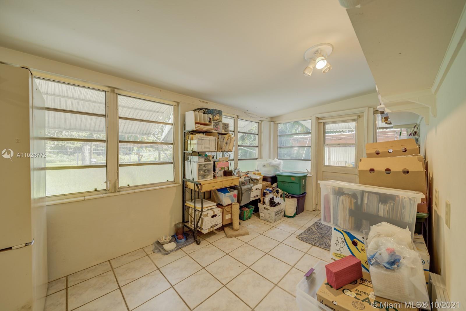 477 Northeast 154th Street Miami, FL 33162 - Photo 22 of 26 a living room with furniture and a window