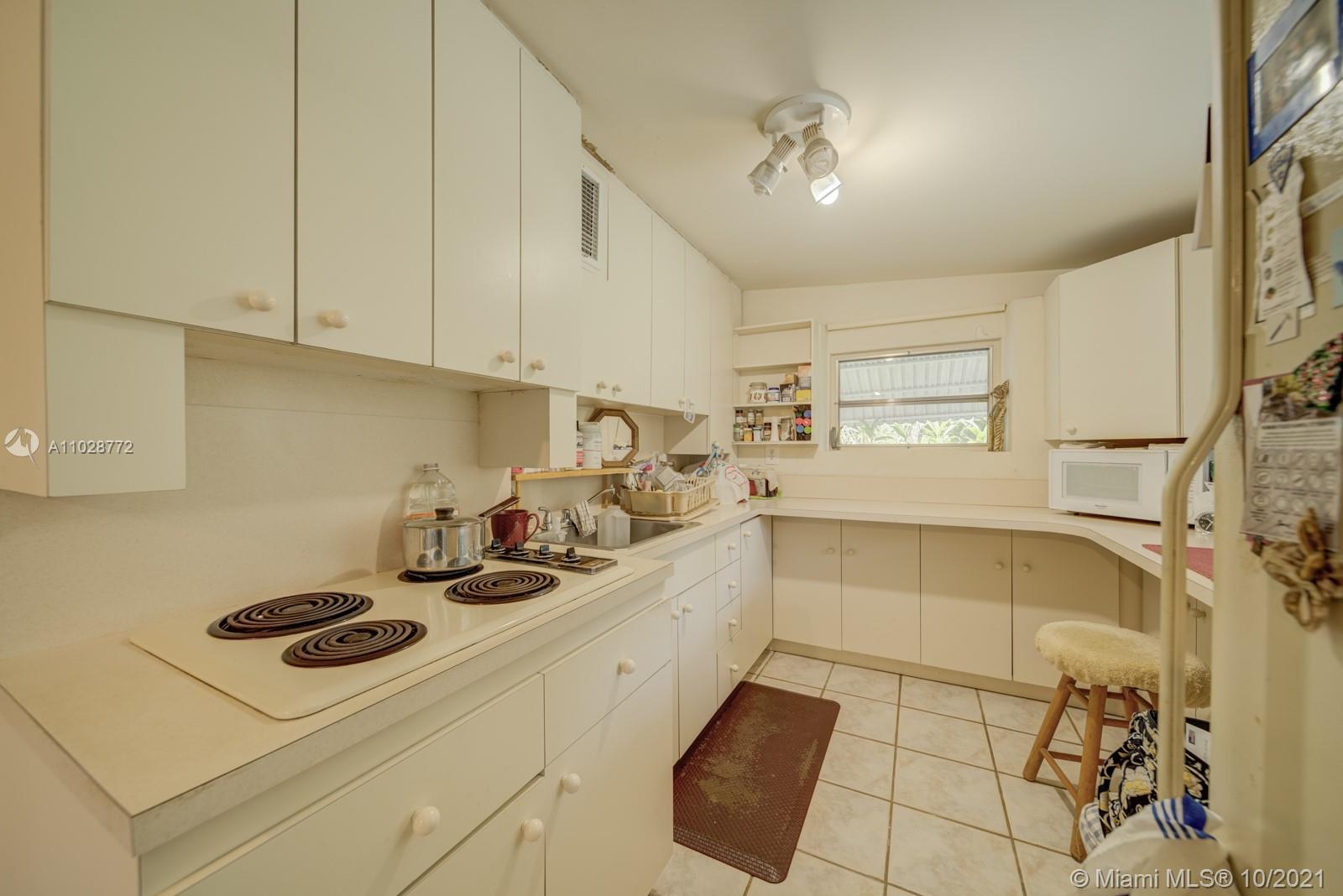 477 Northeast 154th Street Miami, FL 33162 - Photo 25 of 26 a kitchen with sink cabinets and window