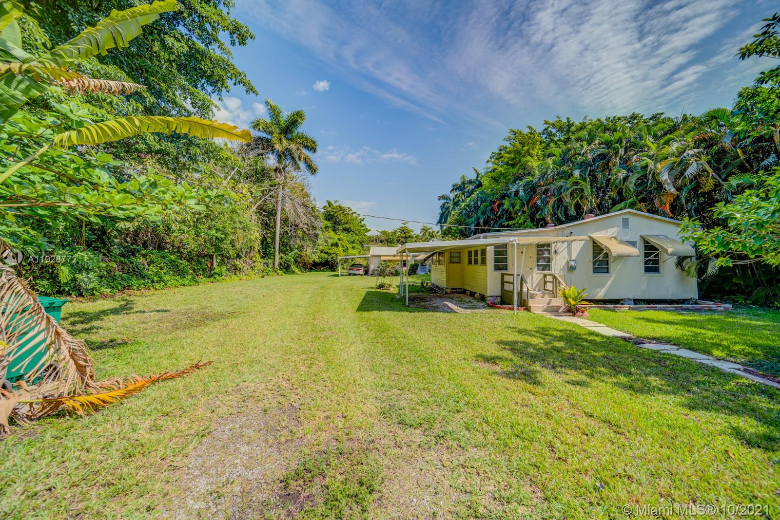 477 Northeast 154th Street Miami, FL 33162 - Photo 26 of 26 a front view of house with yard and trees