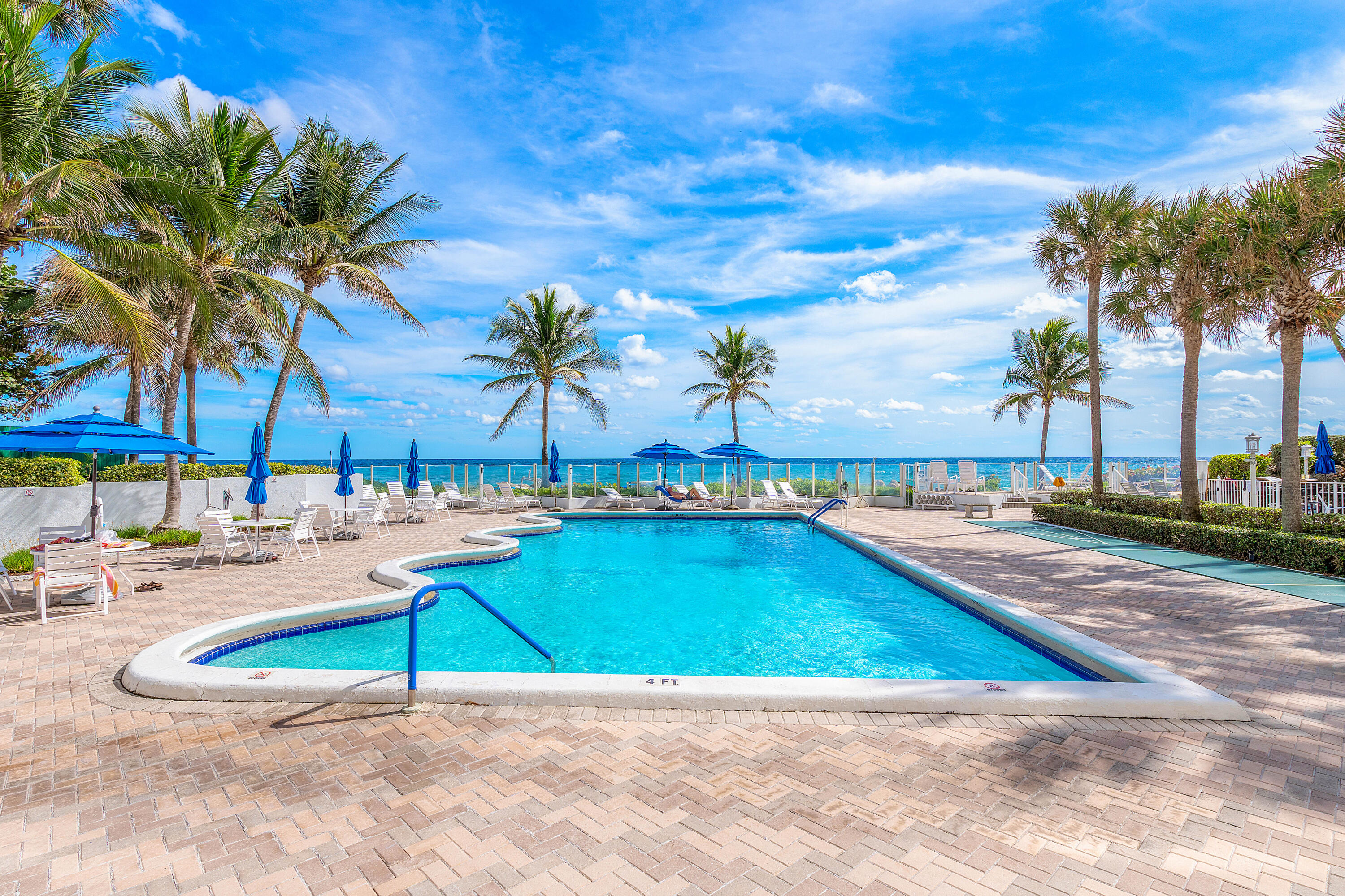 500 Southeast 21st Avenue, Unit 409 Deerfield Beach, FL 33441 - Photo 11 of 14 a view of a swimming pool with lounge chairs