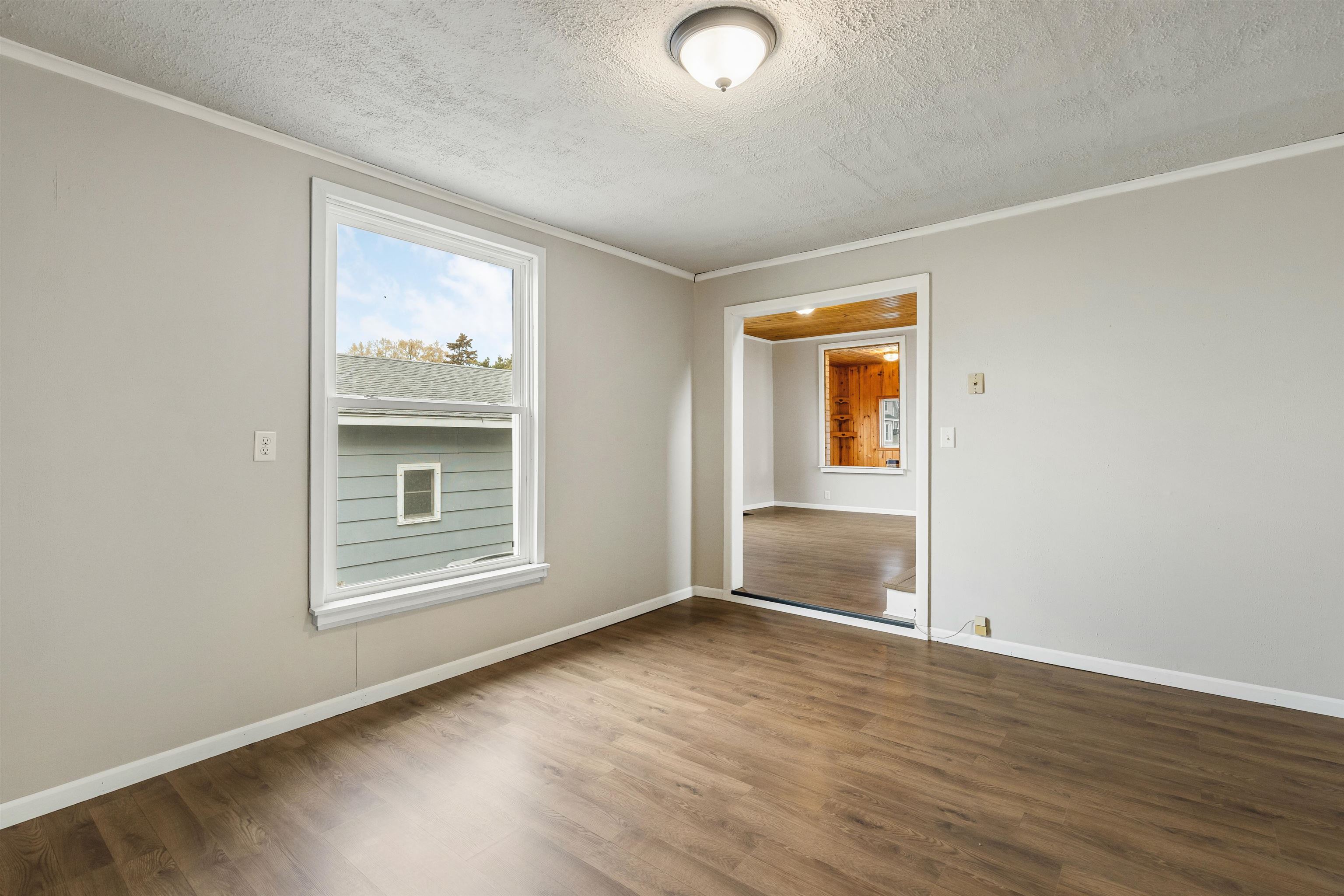 209 South Elida Street Winnebago, IL 61088 - Photo 17 of 48 an empty room with wooden floor and windows