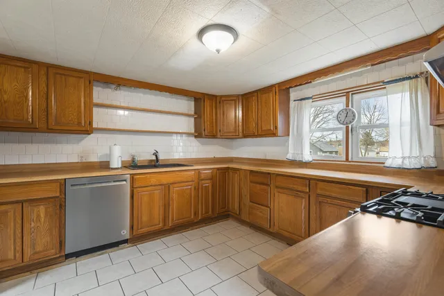 a kitchen with a sink window and cabinets