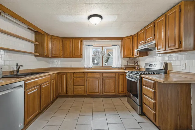 a kitchen with a stove and a refrigerator