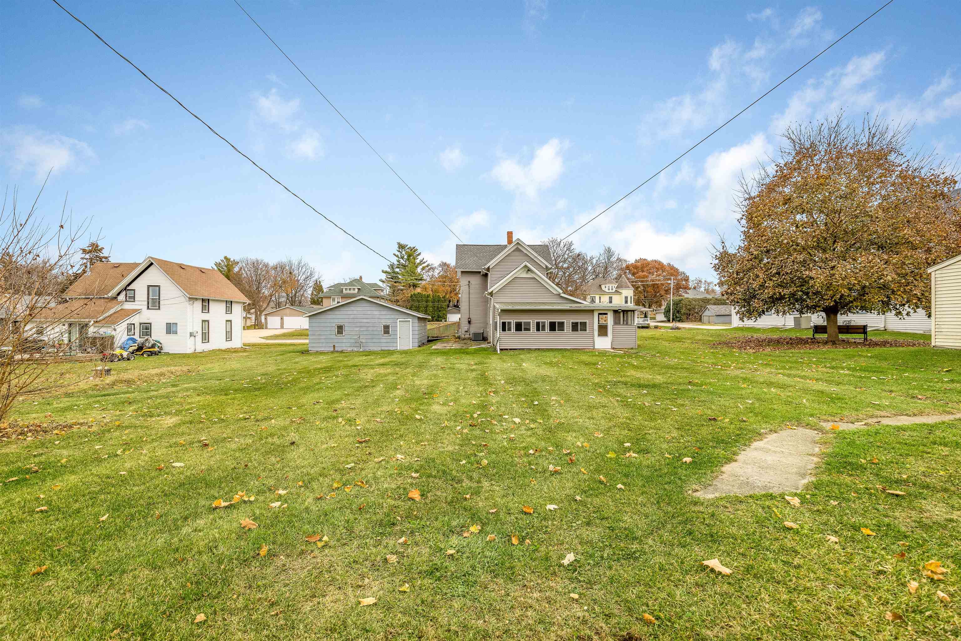 209 South Elida Street Winnebago, IL 61088 - Photo 38 of 48 a view of white house with pool and yard