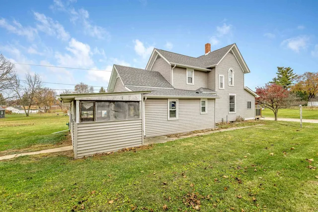 an aerial view of a house with garden space and street view