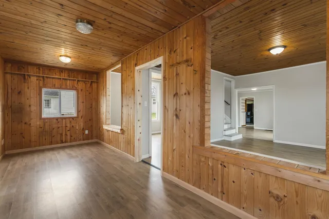 a view of a hallway with wooden floor and staircase
