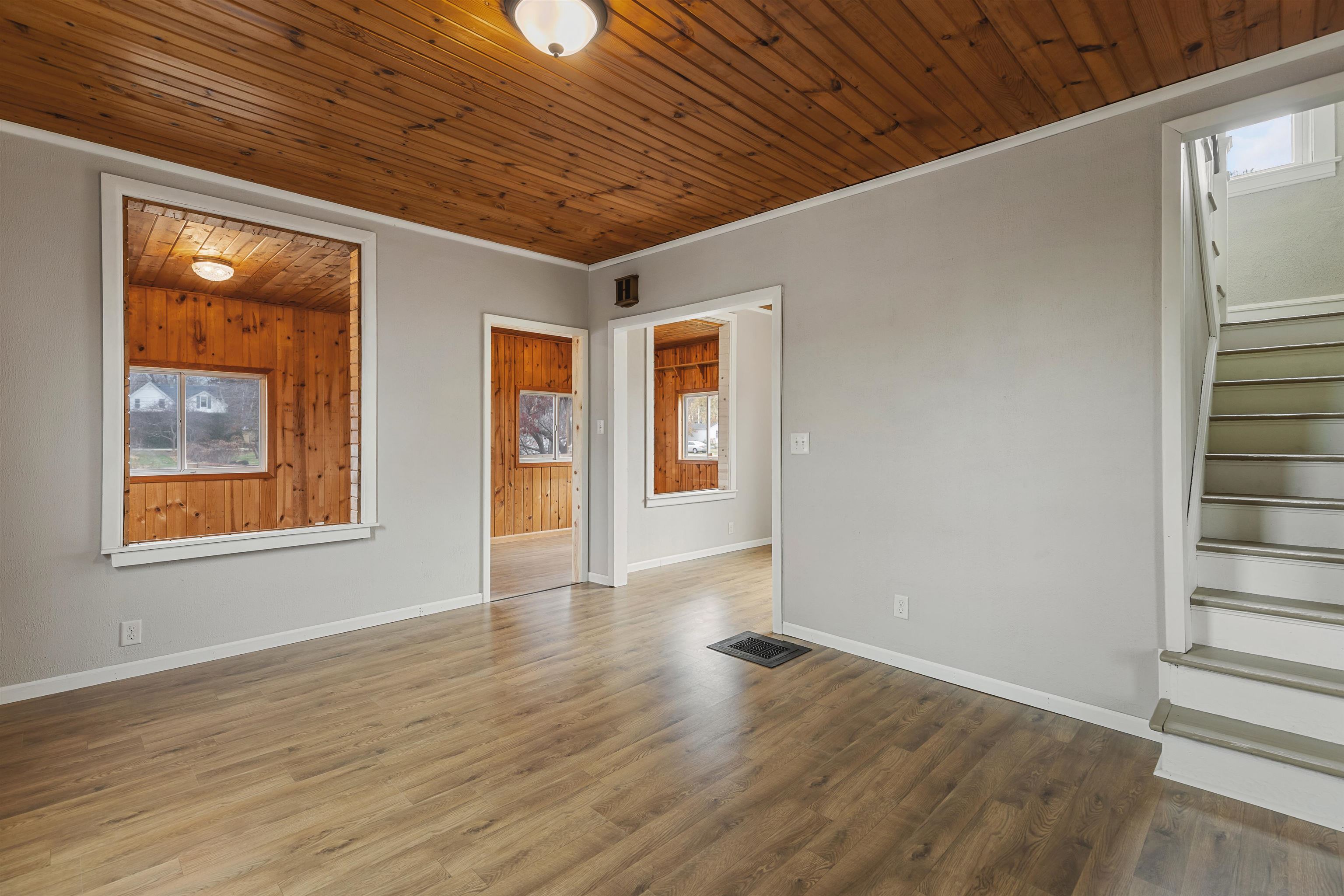 209 South Elida Street Winnebago, IL 61088 - Photo 7 of 48 a view of an empty room with wooden floor and a window