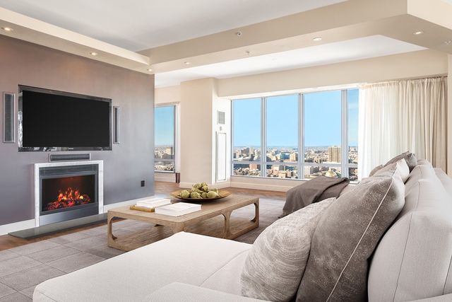 a living room with furniture a flat screen tv and a fireplace