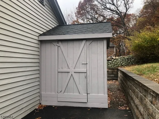 a backyard of a house with barbeque oven