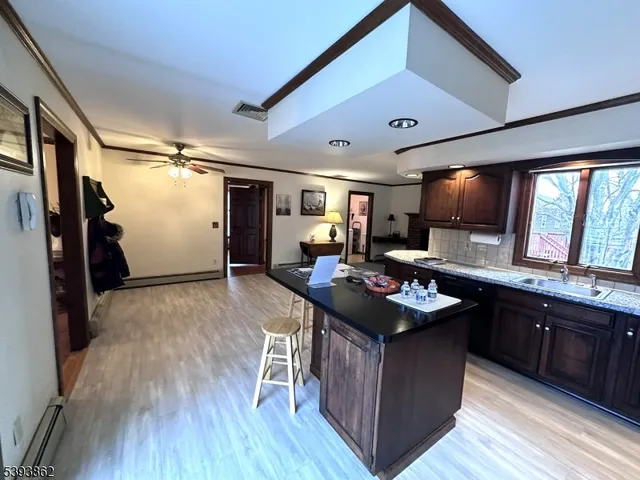 a bathroom with a granite countertop sink a toilet and a shower