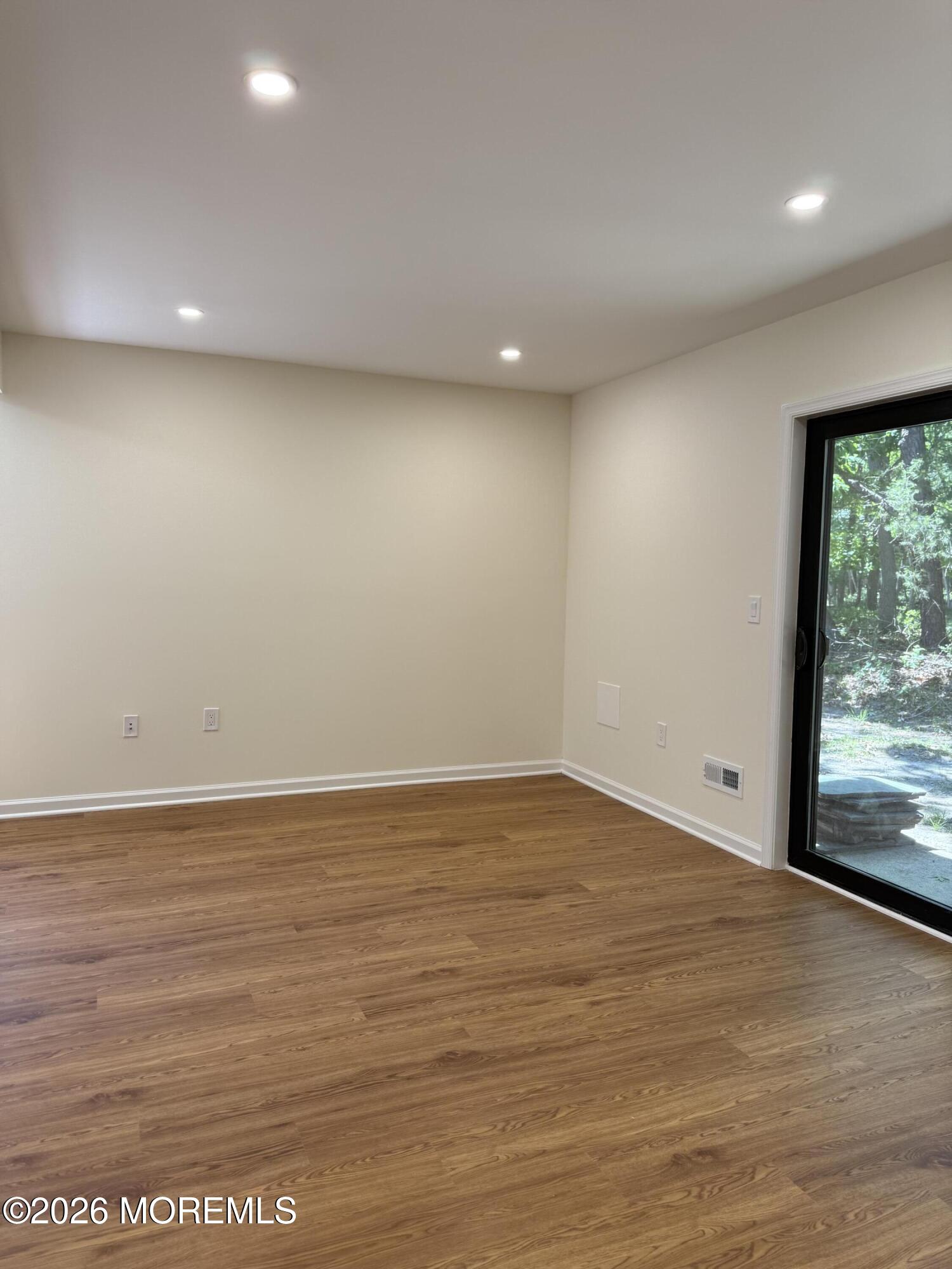 5 Canary Circle Howell, NJ 07731 - Photo 8 of 32 an empty room with wooden floor and windows
