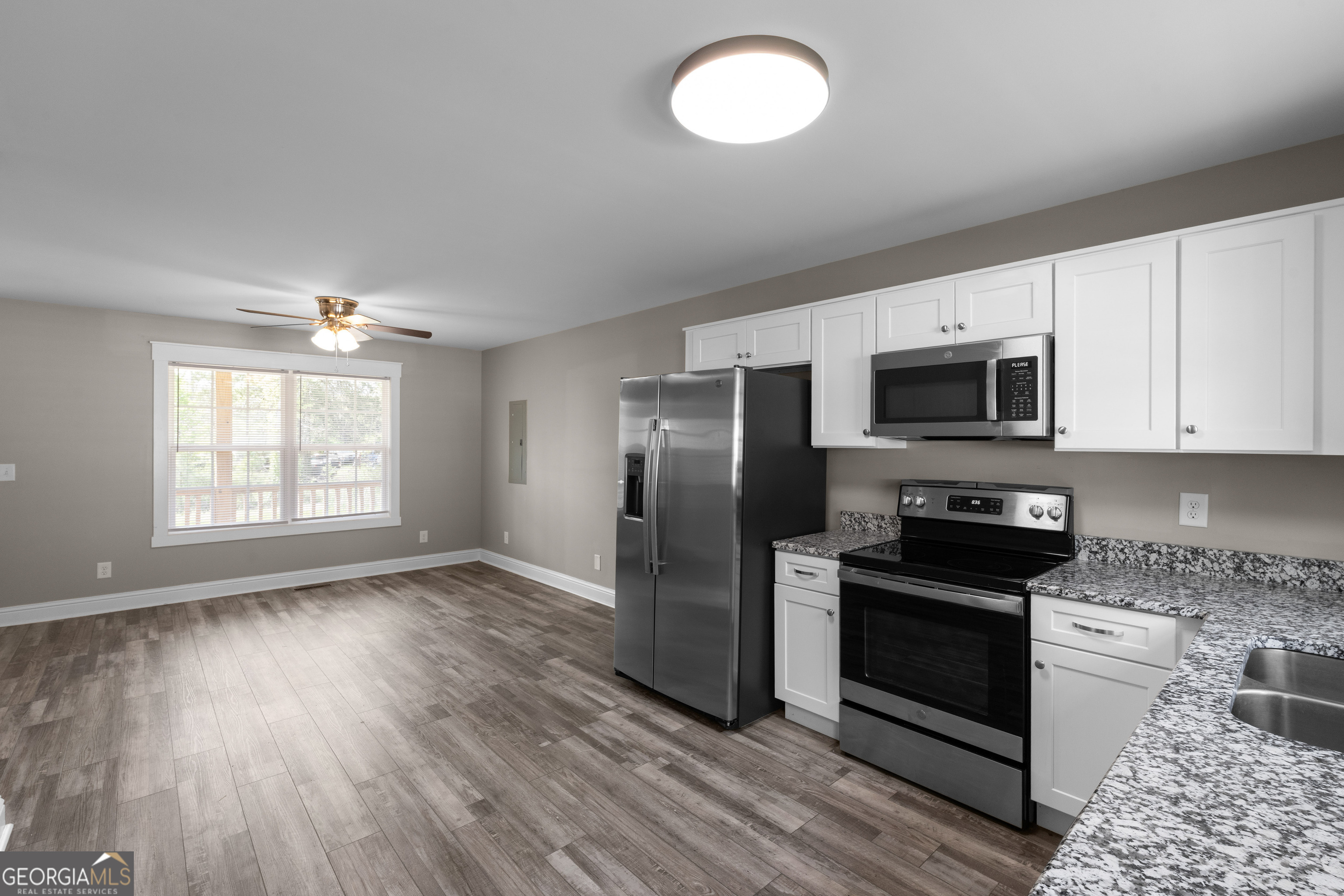 115 Buster Lane Rocky Face, GA 30740 - Photo 13 of 28 a kitchen with stainless steel appliances granite countertop a refrigerator microwave and sink