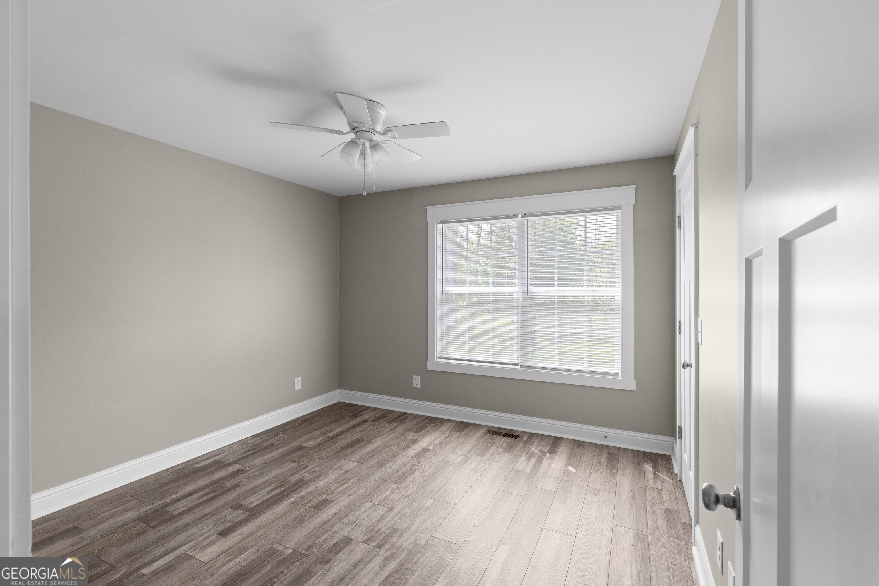 115 Buster Lane Rocky Face, GA 30740 - Photo 21 of 28 a view of an empty room with wooden floor and a window