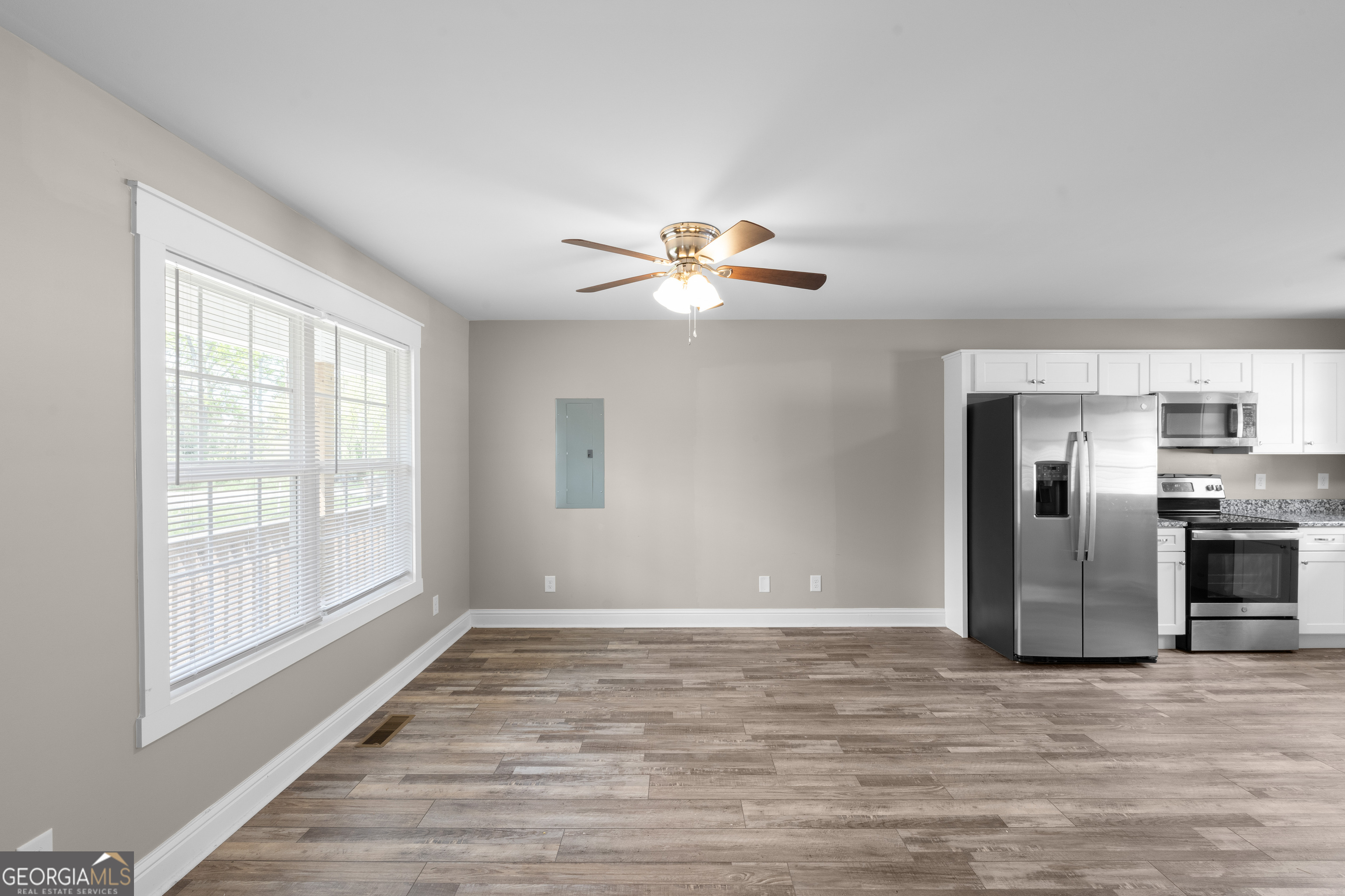 115 Buster Lane Rocky Face, GA 30740 - Photo 7 of 28 a view of a kitchen with a stove cabinets a ceiling fan and wooden floor