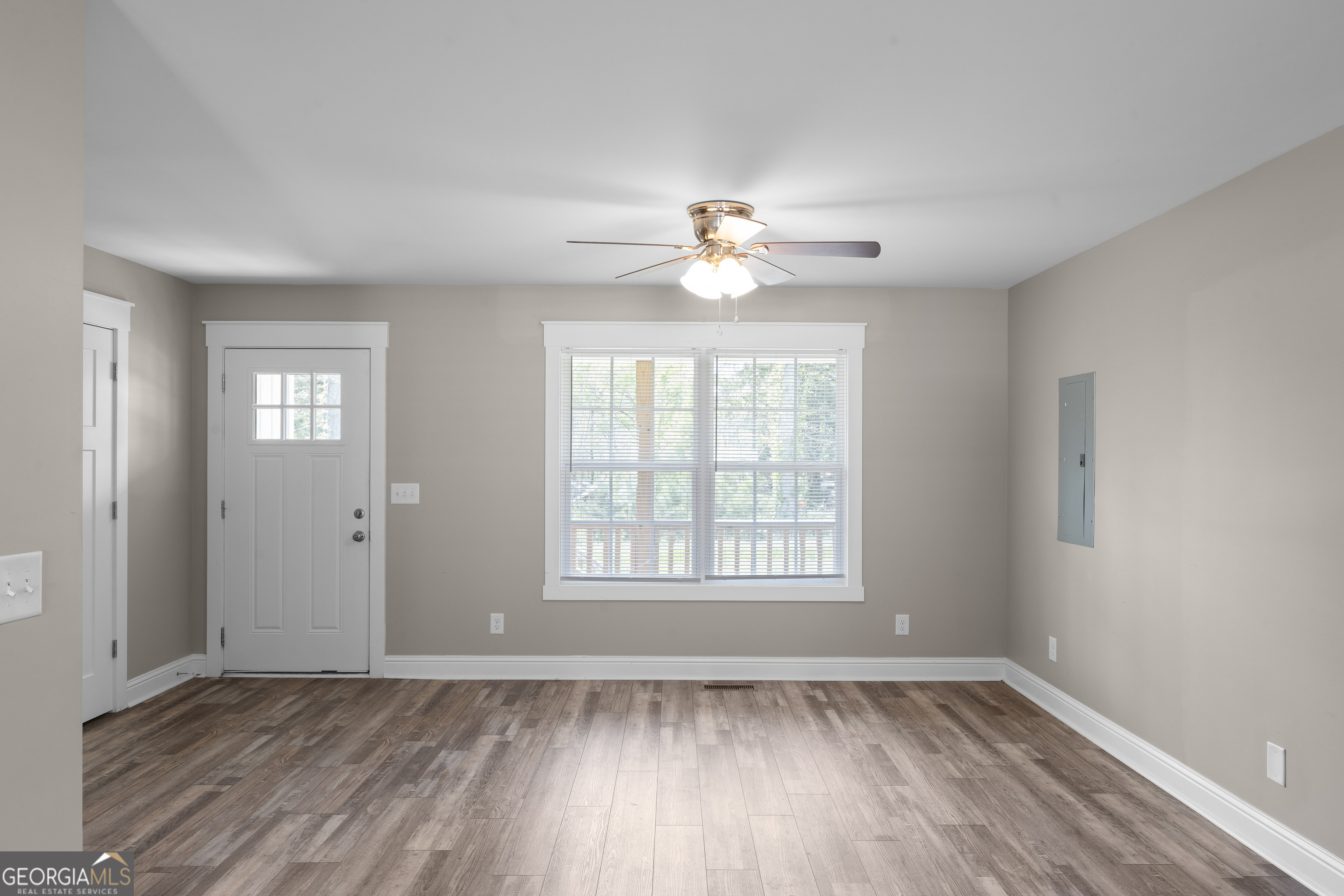 115 Buster Lane Rocky Face, GA 30740 - Photo 8 of 28 a view of an empty room with a window and wooden floor