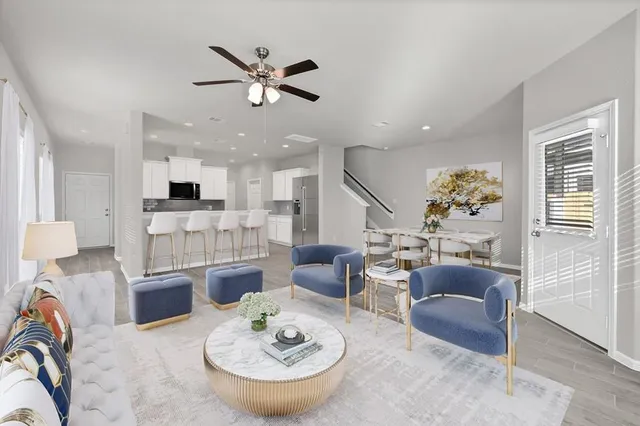 a kitchen with granite countertop a sink and dishwasher a stove top oven with white cabinets