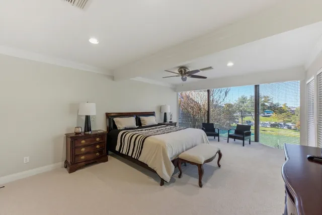 a spacious bedroom with a bed and a large window