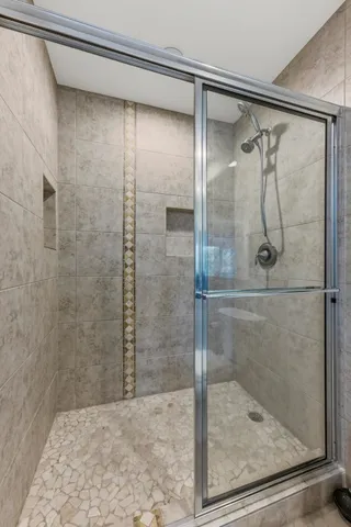 a bathroom with a glass shower door