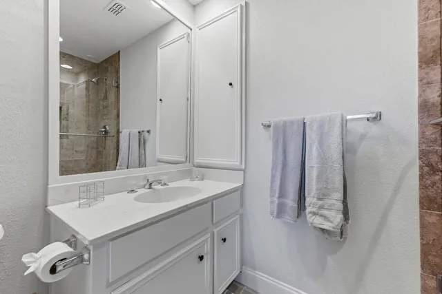 a bedroom with a bed lamp and a large window