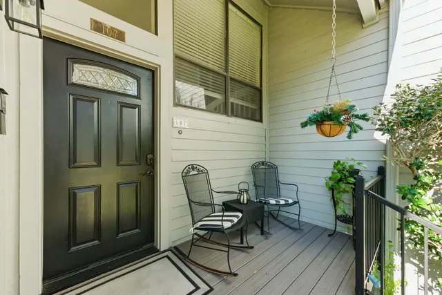 a view of a door with a chairs and table in a patio