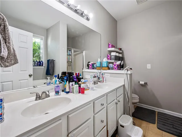 a bathroom with a sink mirror vanity and toilet