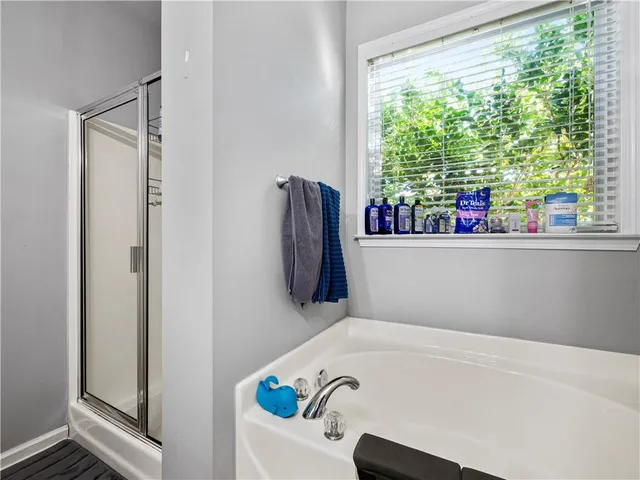 a bathroom with a tub and a window