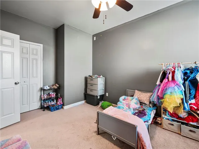 a bedroom with bed and a chandelier