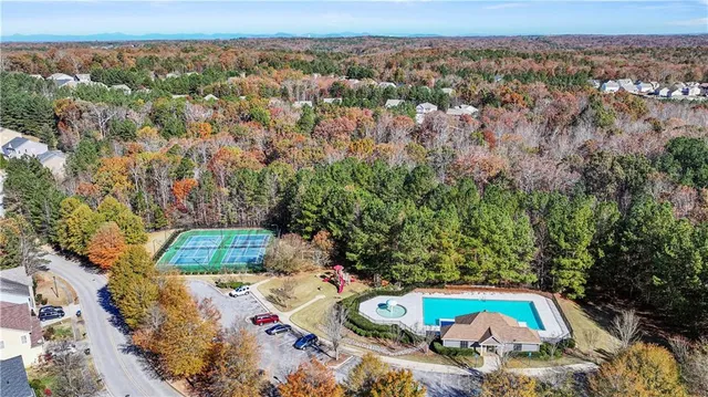 an aerial view of a house with a yard
