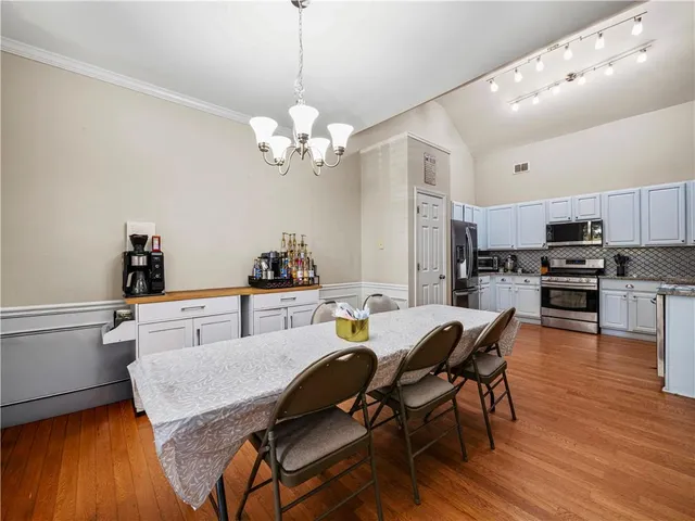a view of a dining room with furniture and wooden floor