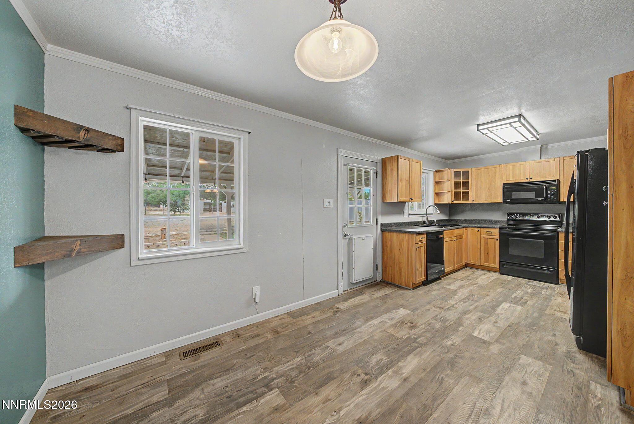 11577 Deodar Way Reno, NV 89506 - Photo 13 of 58 a kitchen with stainless steel appliances granite countertop a stove cabinets and wooden floor