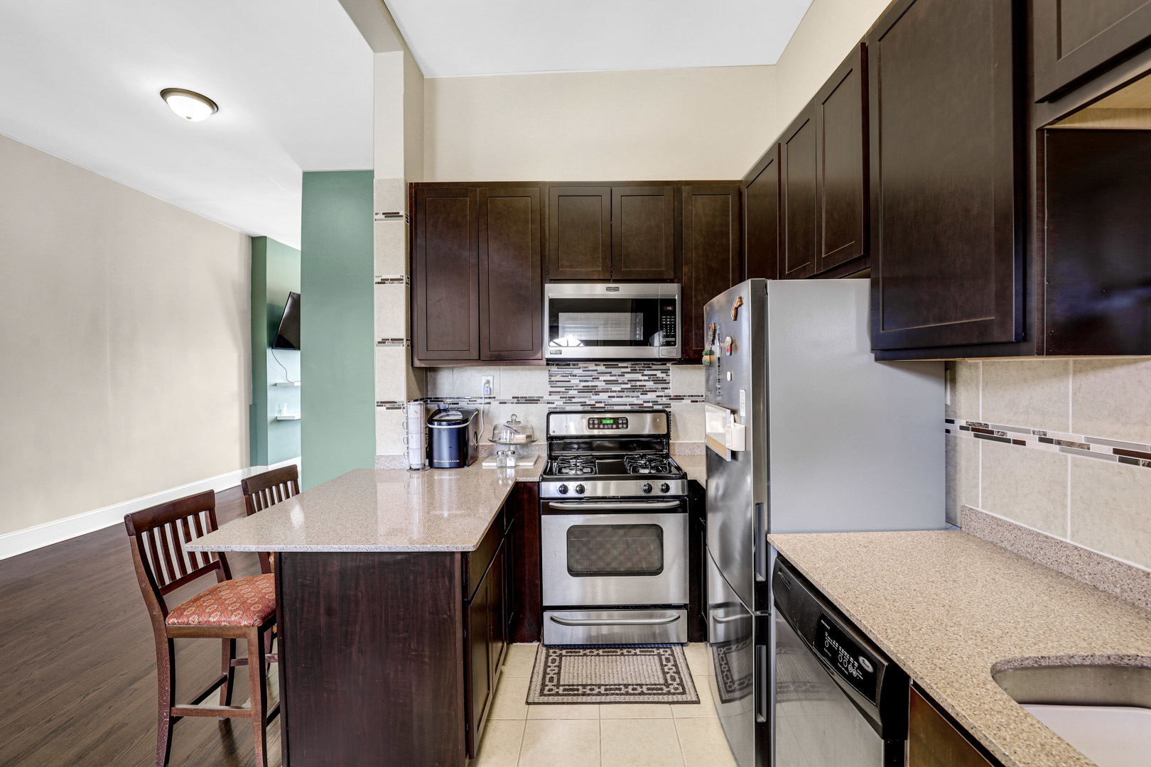 3716 West Cermak Road Chicago, IL 60623 - Photo 8 of 28 a kitchen with a stove a refrigerator and a microwave