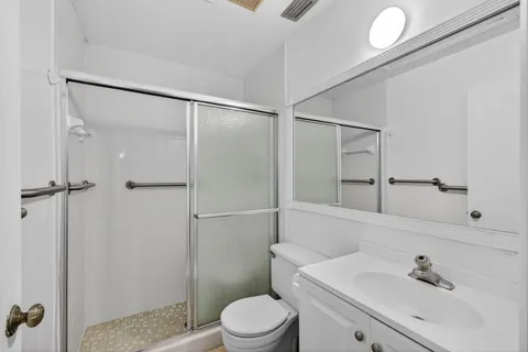 a bathroom with a sink toilet and shower