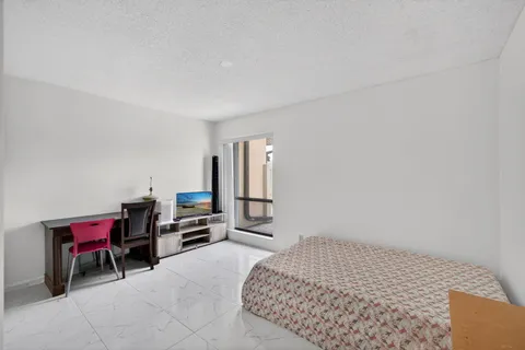 a bedroom with a bed and a desk